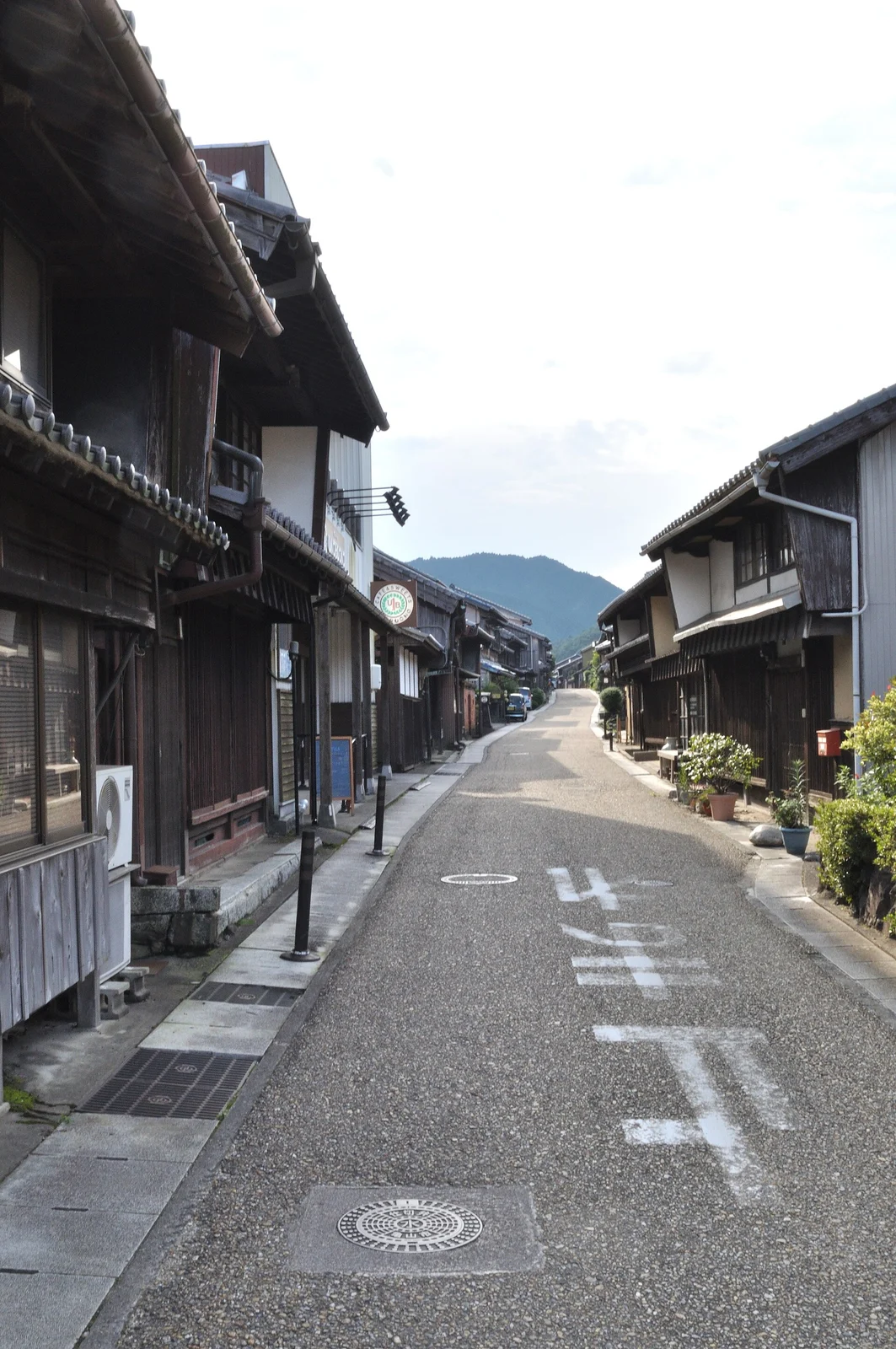 家々と店が並び、路面標示がある関宿の道